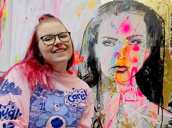Girl sitting in front of her colorful painting, Tanya